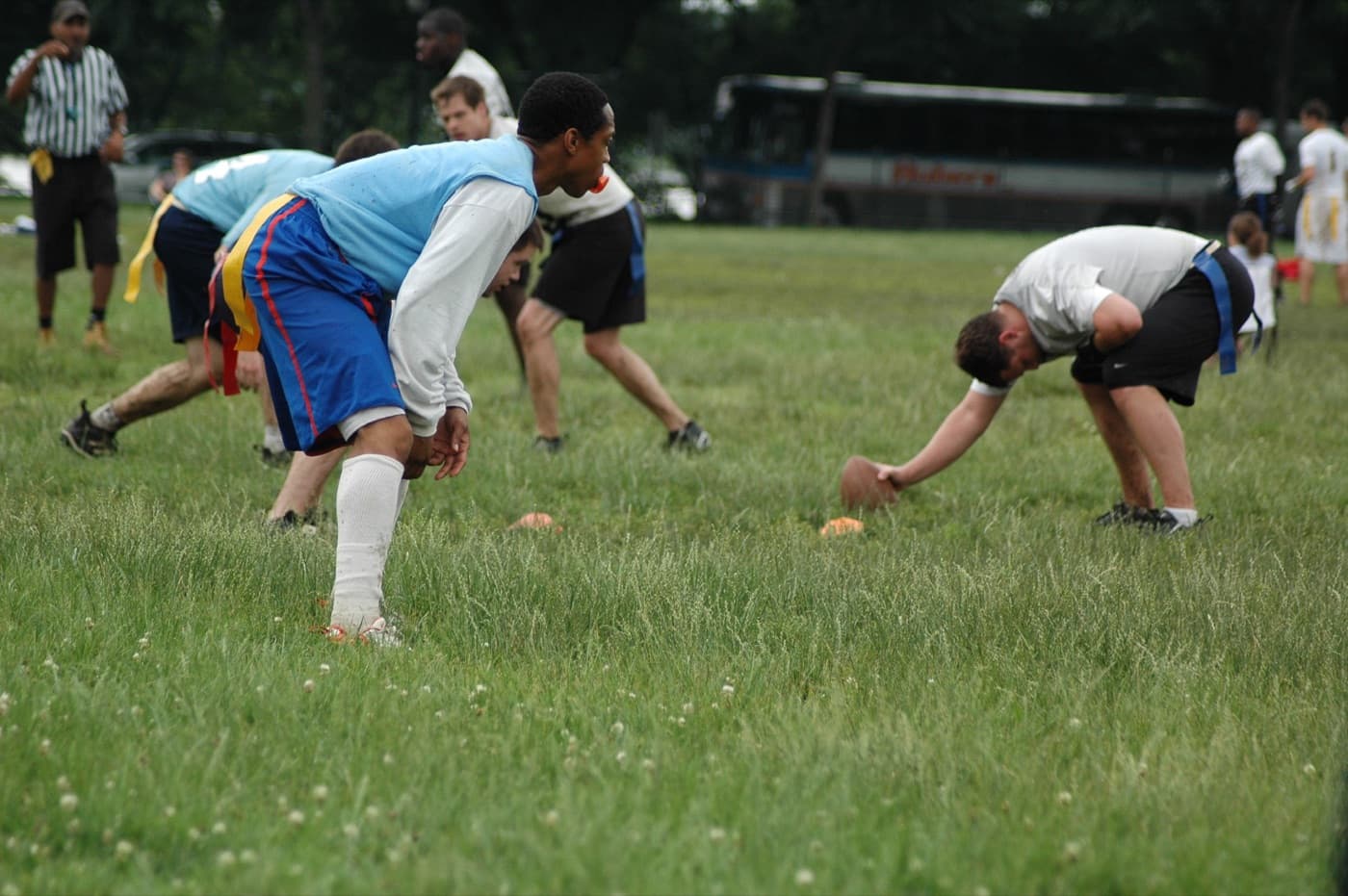 Two lines of players crouched over the ball at the line of scrimmage before the snap