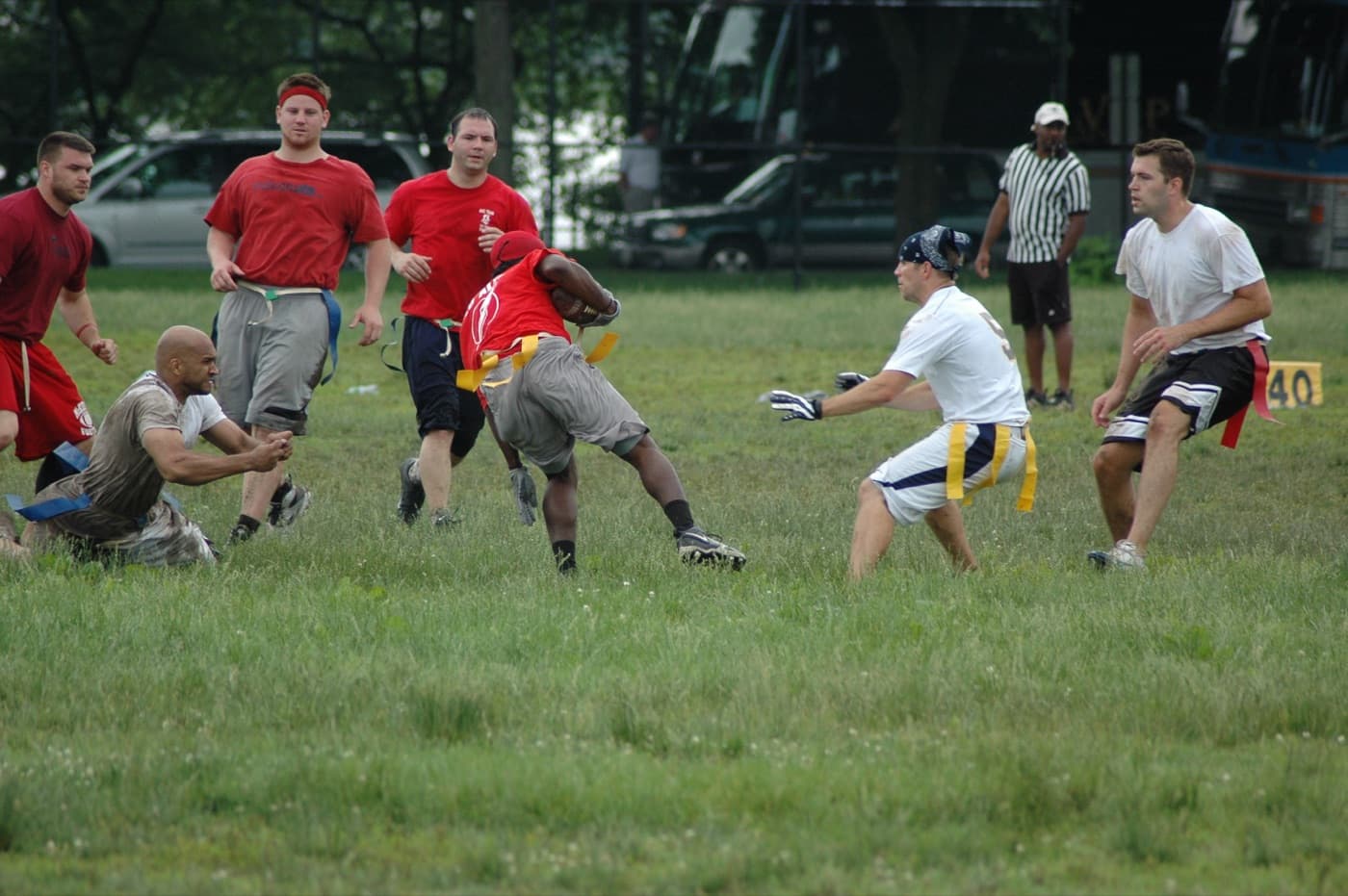 Ball carrier weaving between defenders as they close in on his flags in a 7on7 game