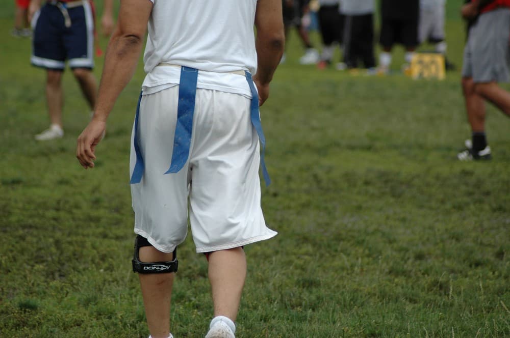 Player seen from behind with both flags still hanging from his belt